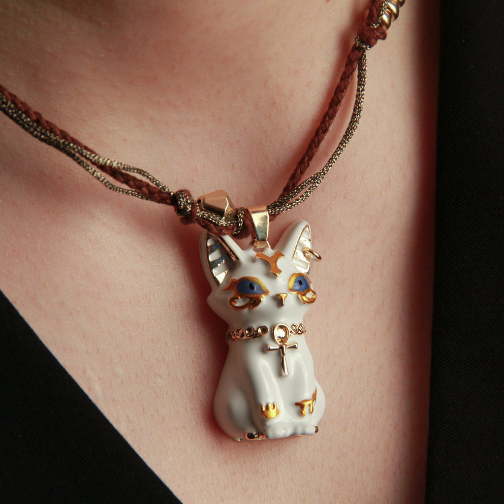 White cat pendant necklace with Egyptian-inspired design, artistic jewelry for cat lovers
