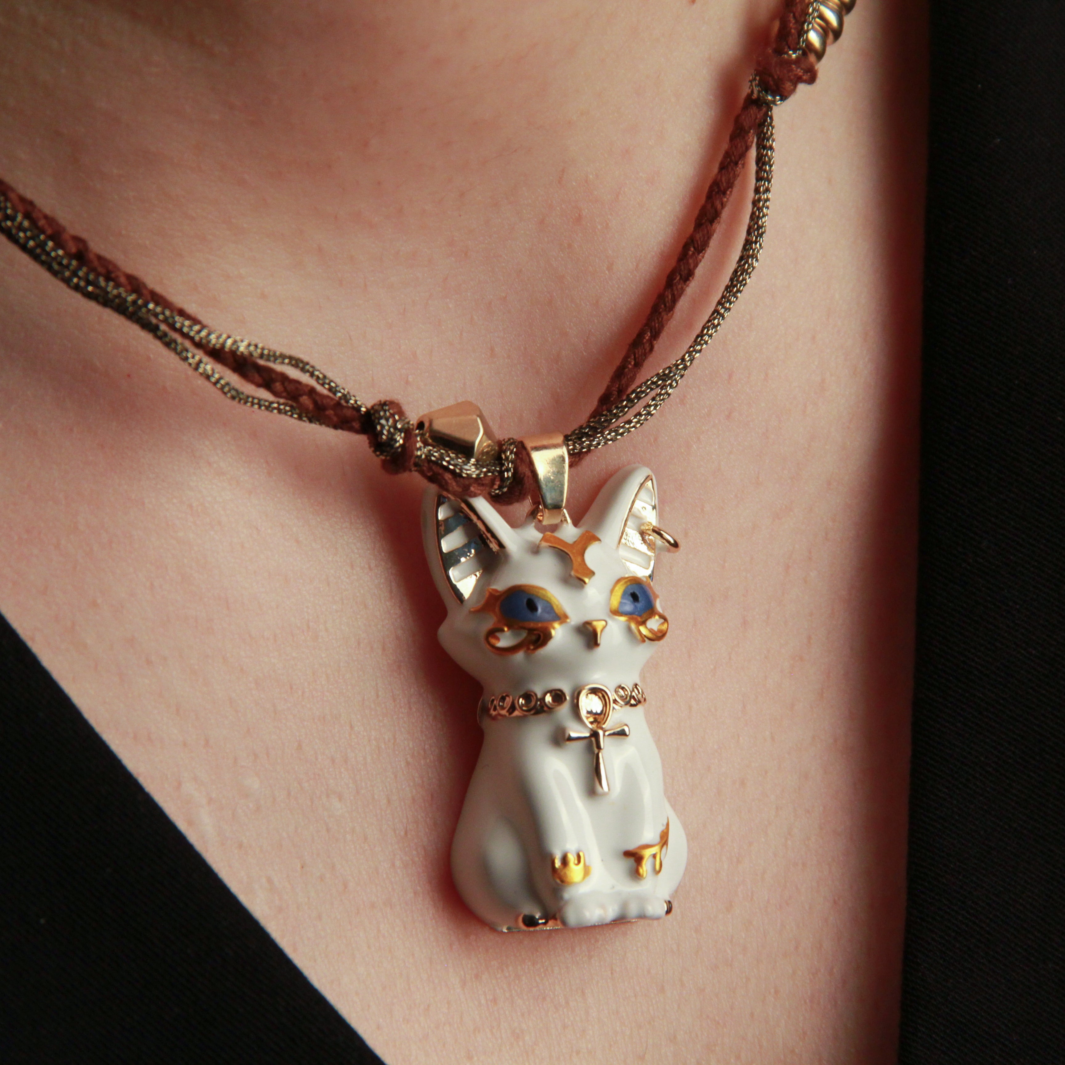 White cat pendant necklace with Egyptian-inspired design, artistic jewelry for cat lovers

