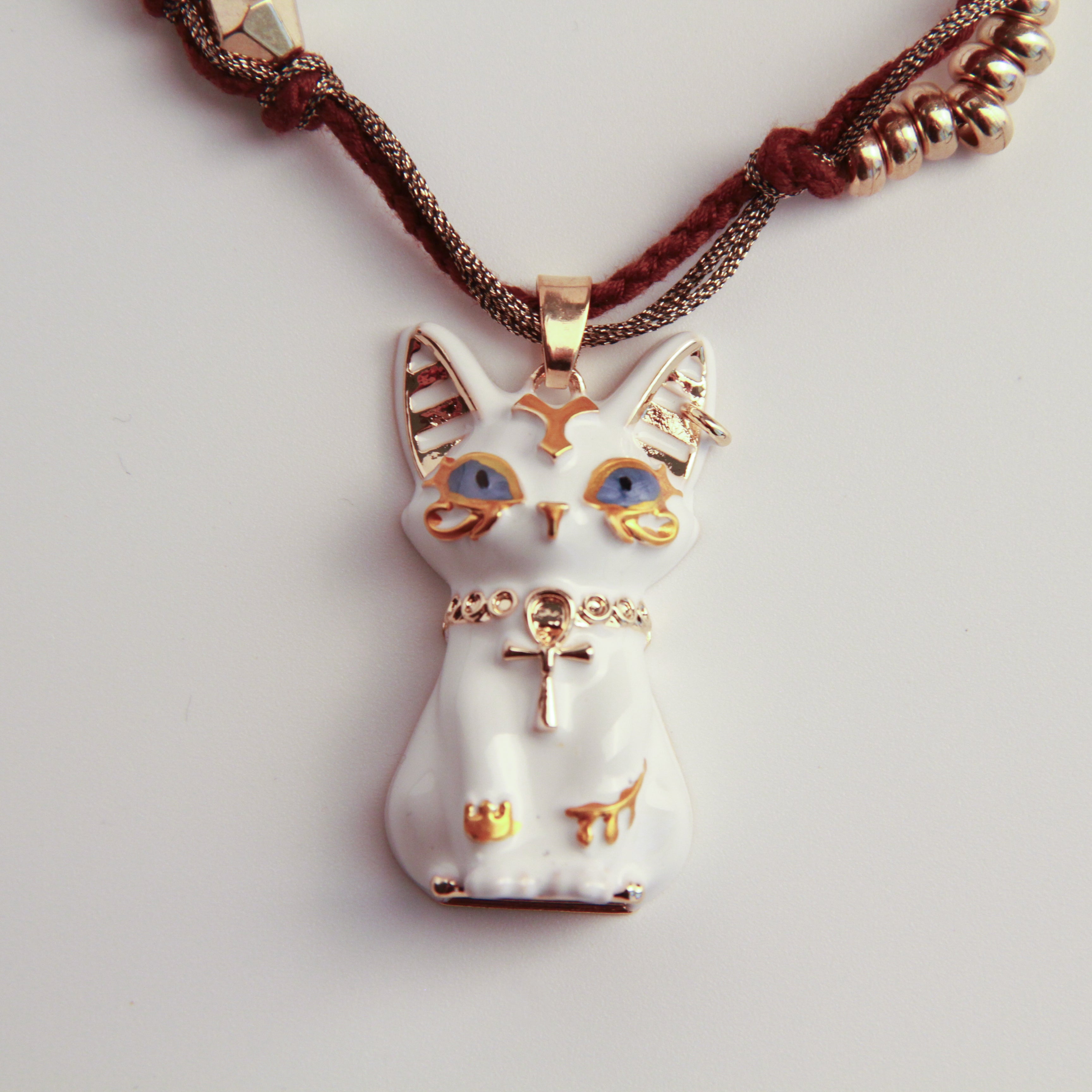 White cat pendant necklace with Egyptian-inspired design, artistic jewelry for cat lovers
