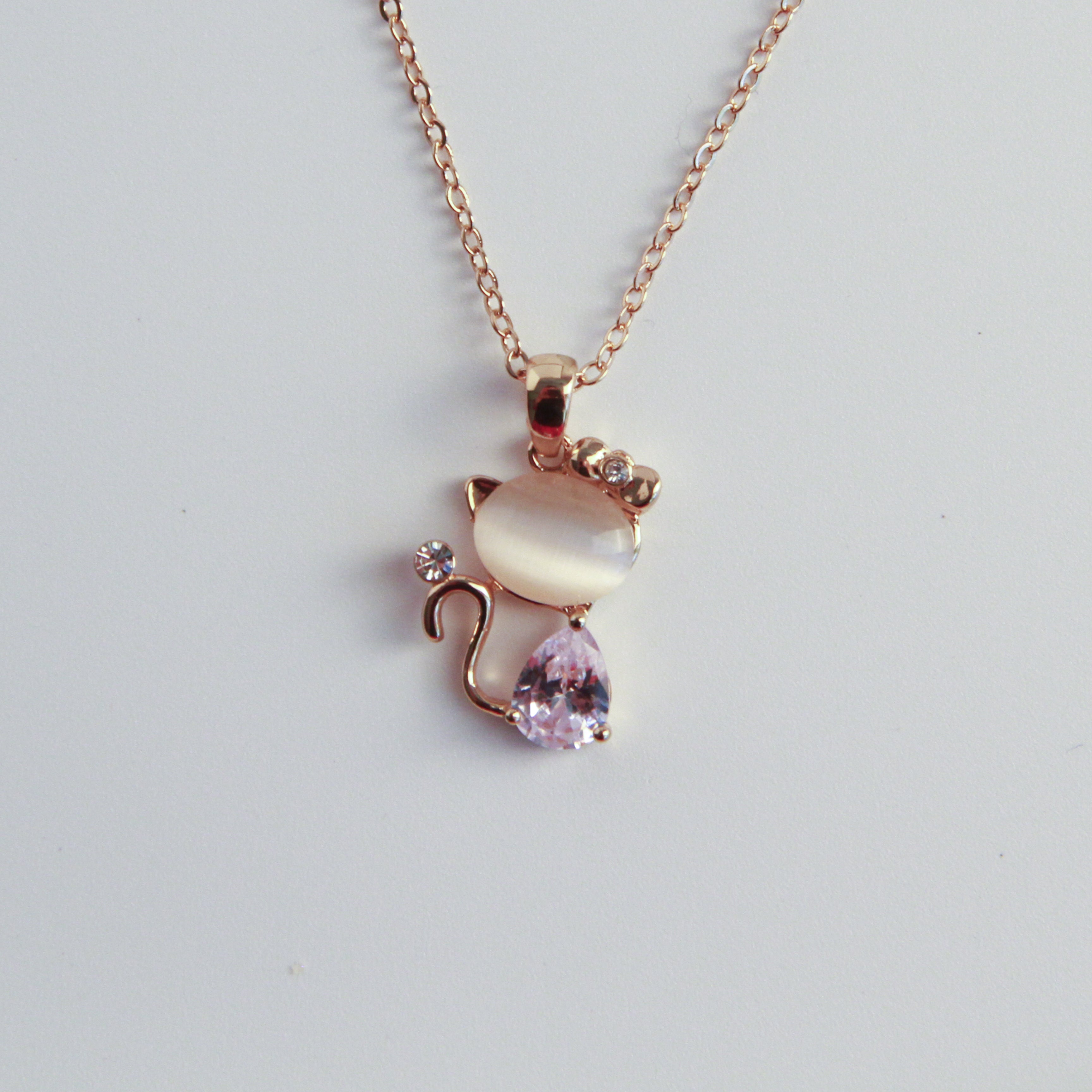 Gold cat necklace with soft stone and crystal details, elegant and feminine jewelry for cat lovers
