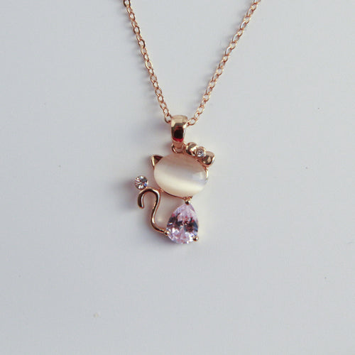 Gold cat necklace with soft stone and crystal details, elegant and feminine jewelry for cat lovers