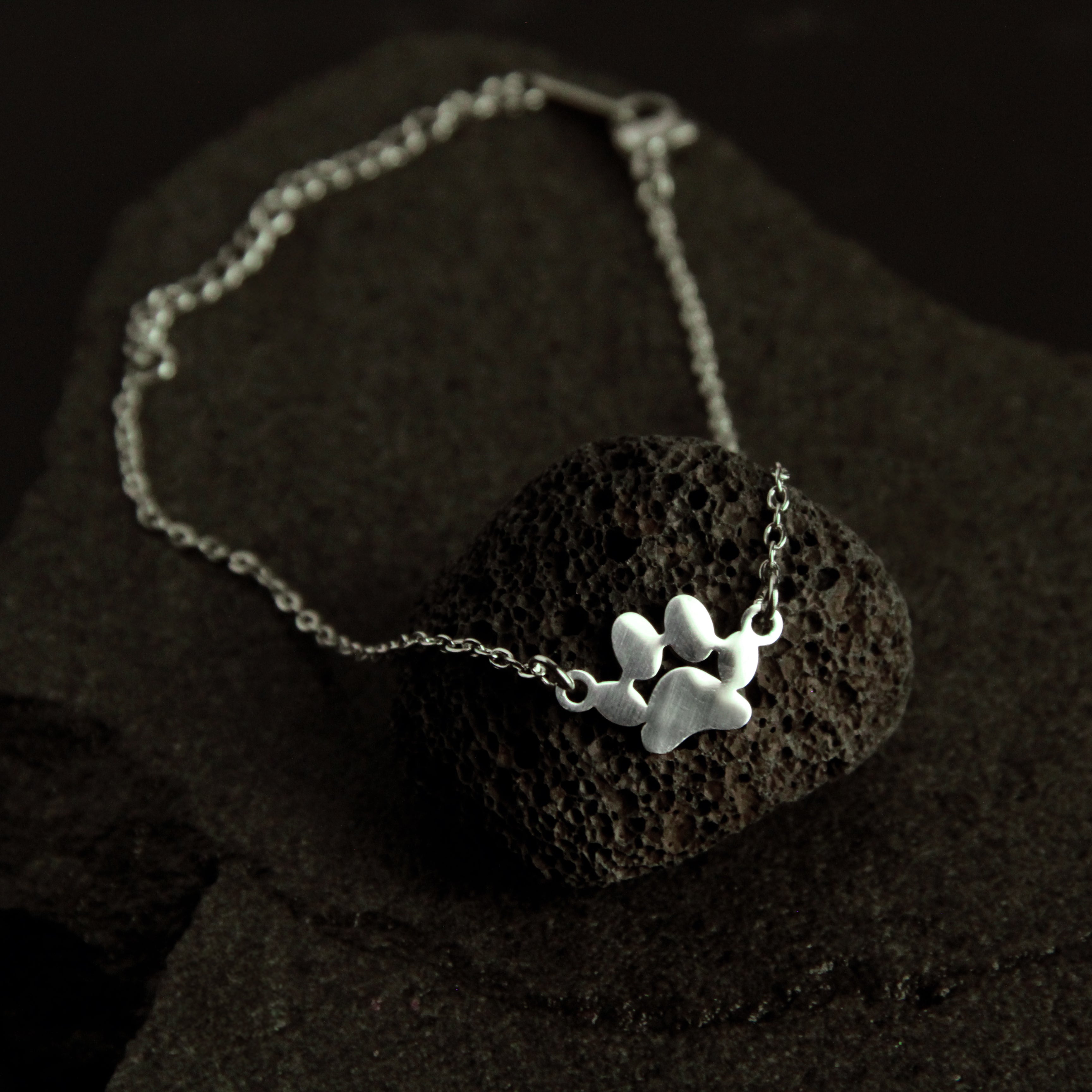 Modern layered silver cat bracelet featuring double chain links and a delicate cat charm, stylish jewelry for cat lovers