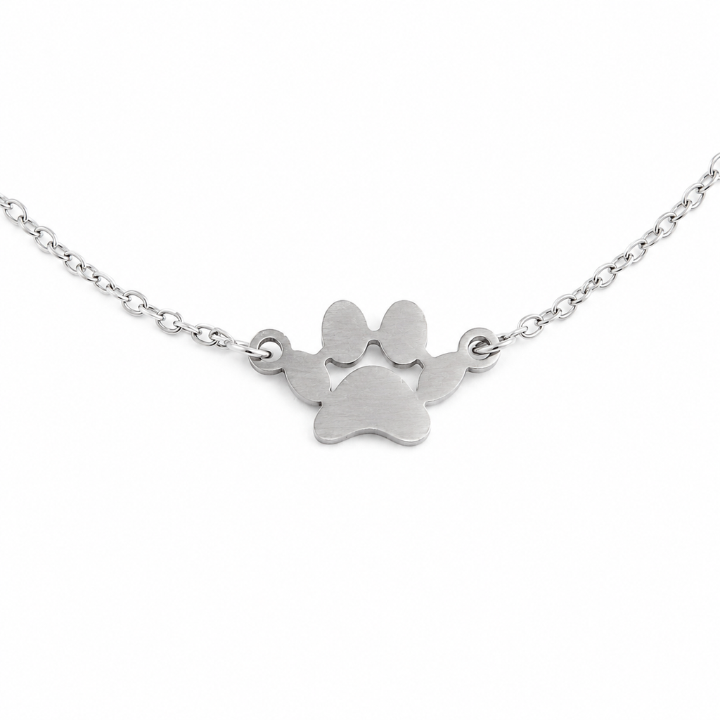 Silver paw print necklace on a white background