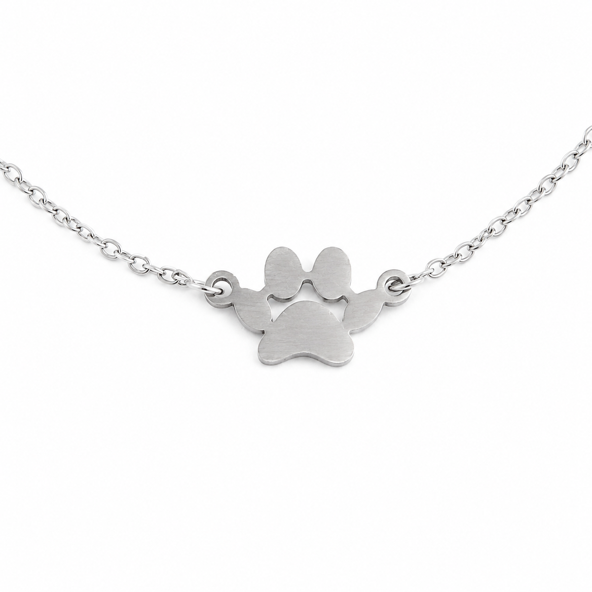 Silver paw print necklace on a white background