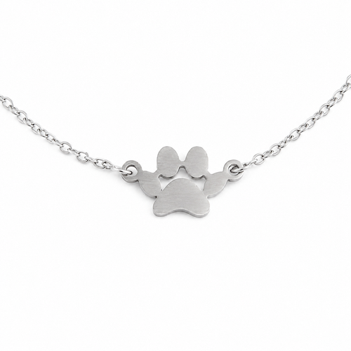 Silver paw print necklace on a white background