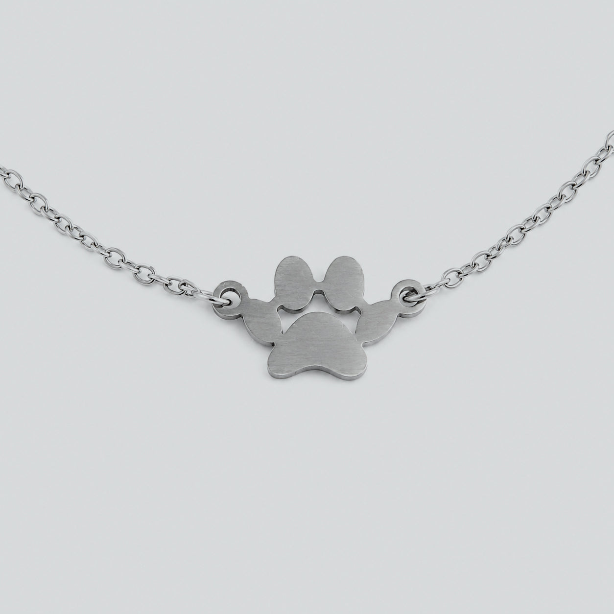 Layered silver cat bracelet with double chain links and cat charm, modern jewelry for cat lovers