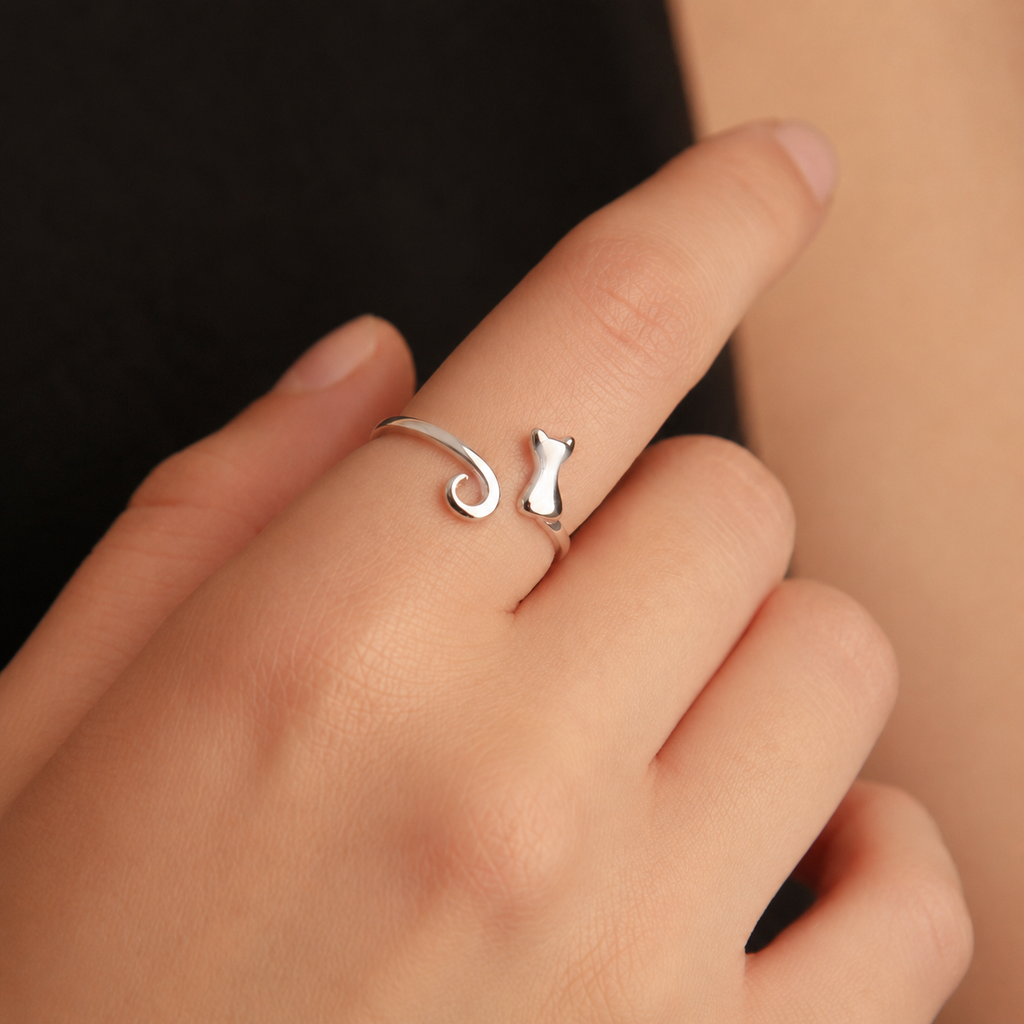 Curled Tail Cat Ring worn on finger close-up