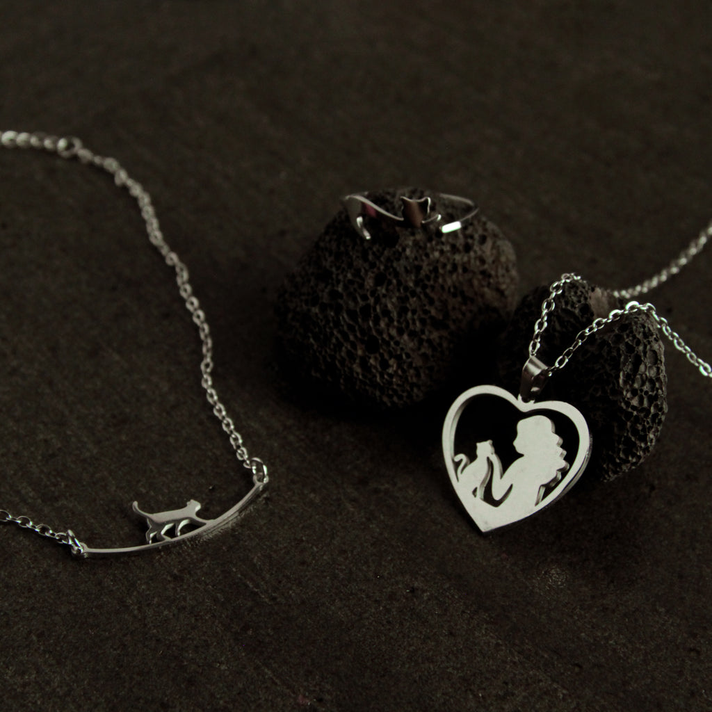 Silver cat jewelry set featuring a cat bracelet, heart-shaped cat necklace, and adjustable ring, elegant gift for cat lovers