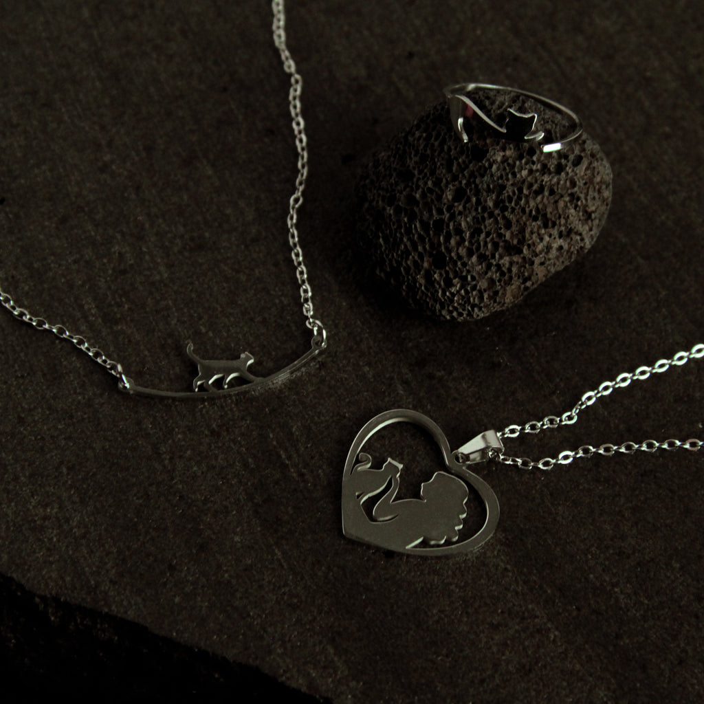 Matching silver cat jewelry set with minimalist bracelet, necklace, and ring, meaningful accessory collection for women