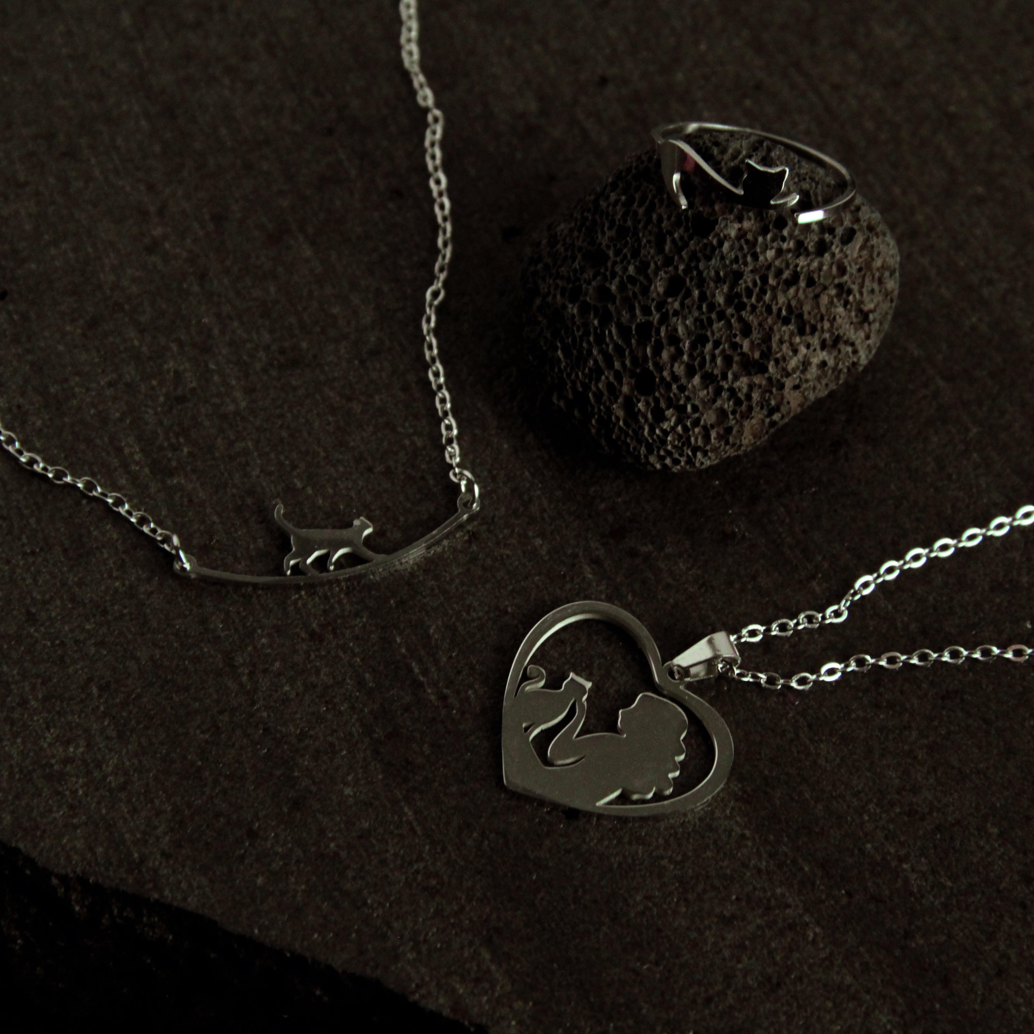 Matching silver cat jewelry set with minimalist bracelet, necklace, and ring, meaningful accessory collection for women