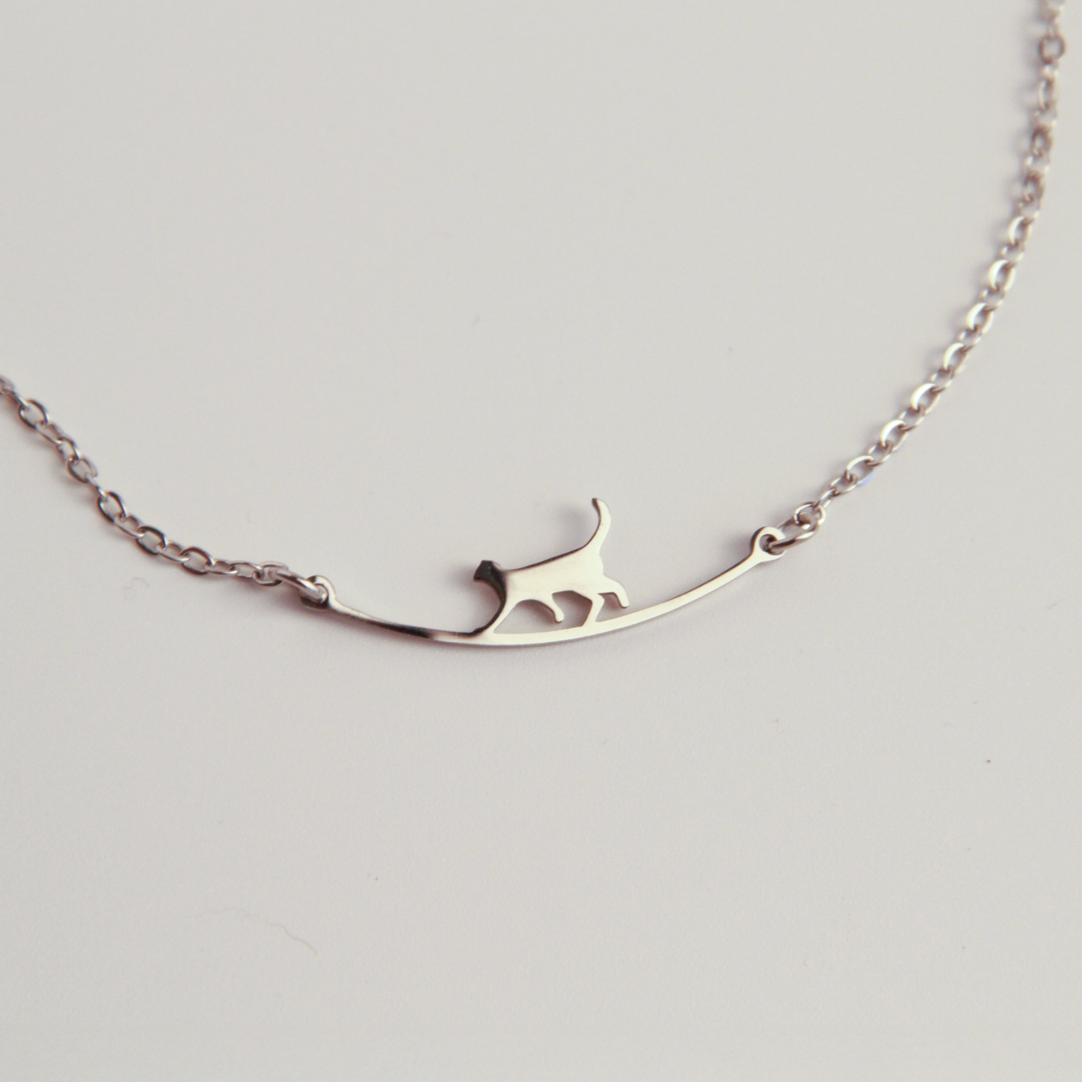 Minimalist silver cat bracelet with delicate cat silhouette, lightweight jewelry for everyday wear