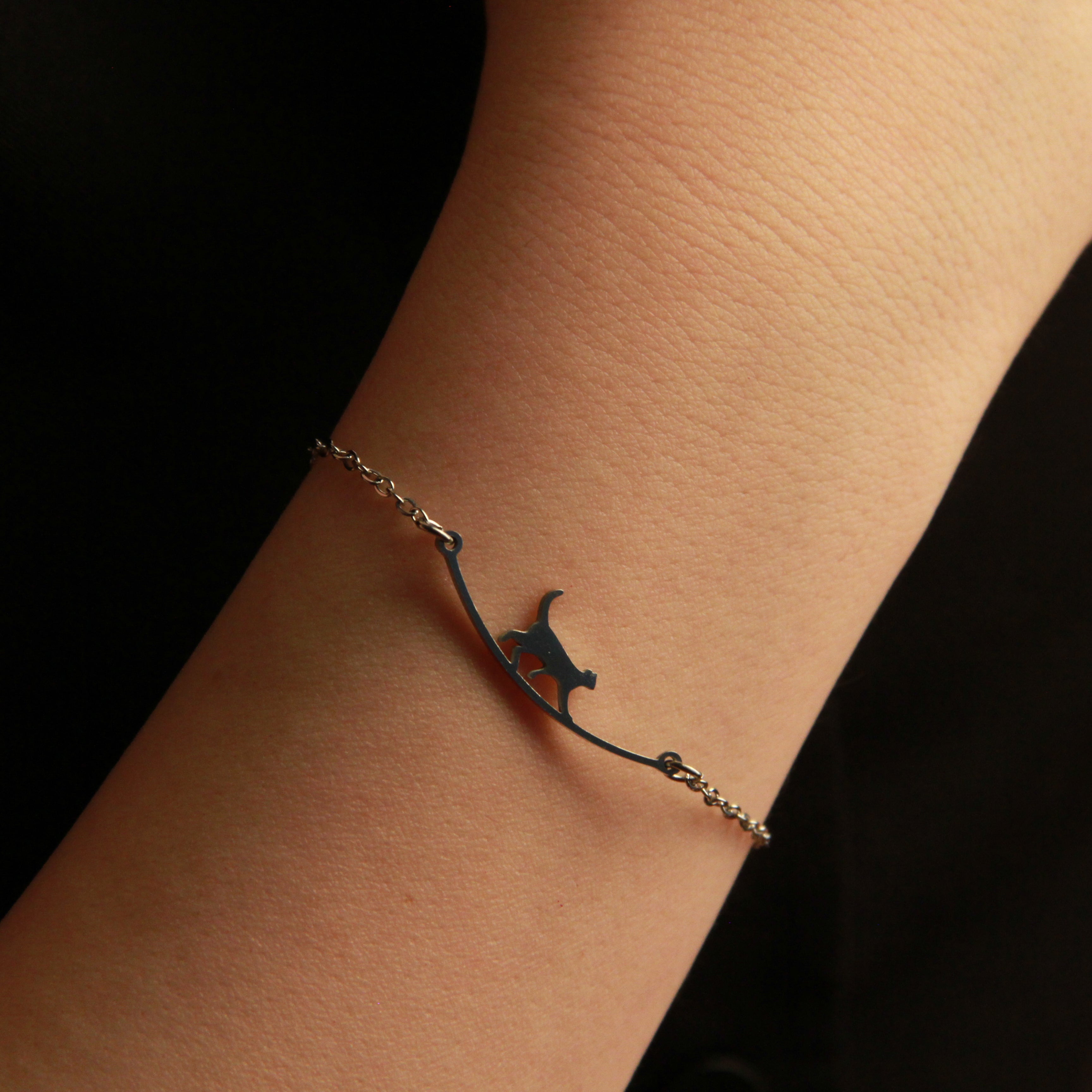 Elegant silver cat charm bracelet featuring a graceful feline design, adjustable accessory for cat lovers