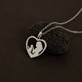 Minimalist heart pendant necklace inspired by the bond between cats and humans.