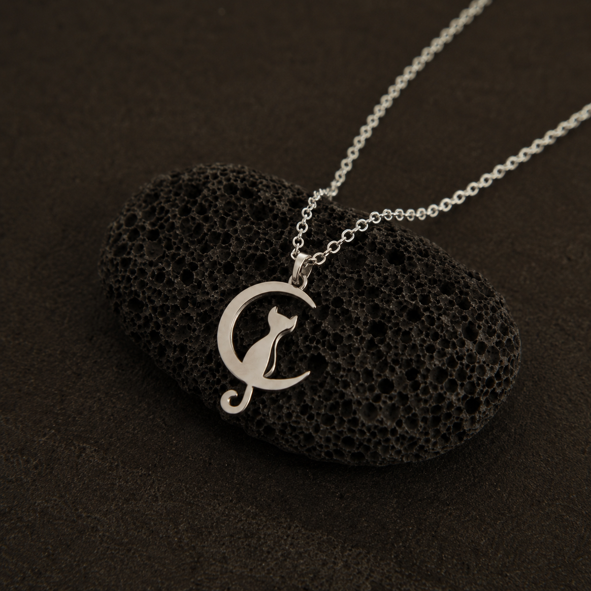 Close-up of Harmony Cat pendant necklace with flowing curved details