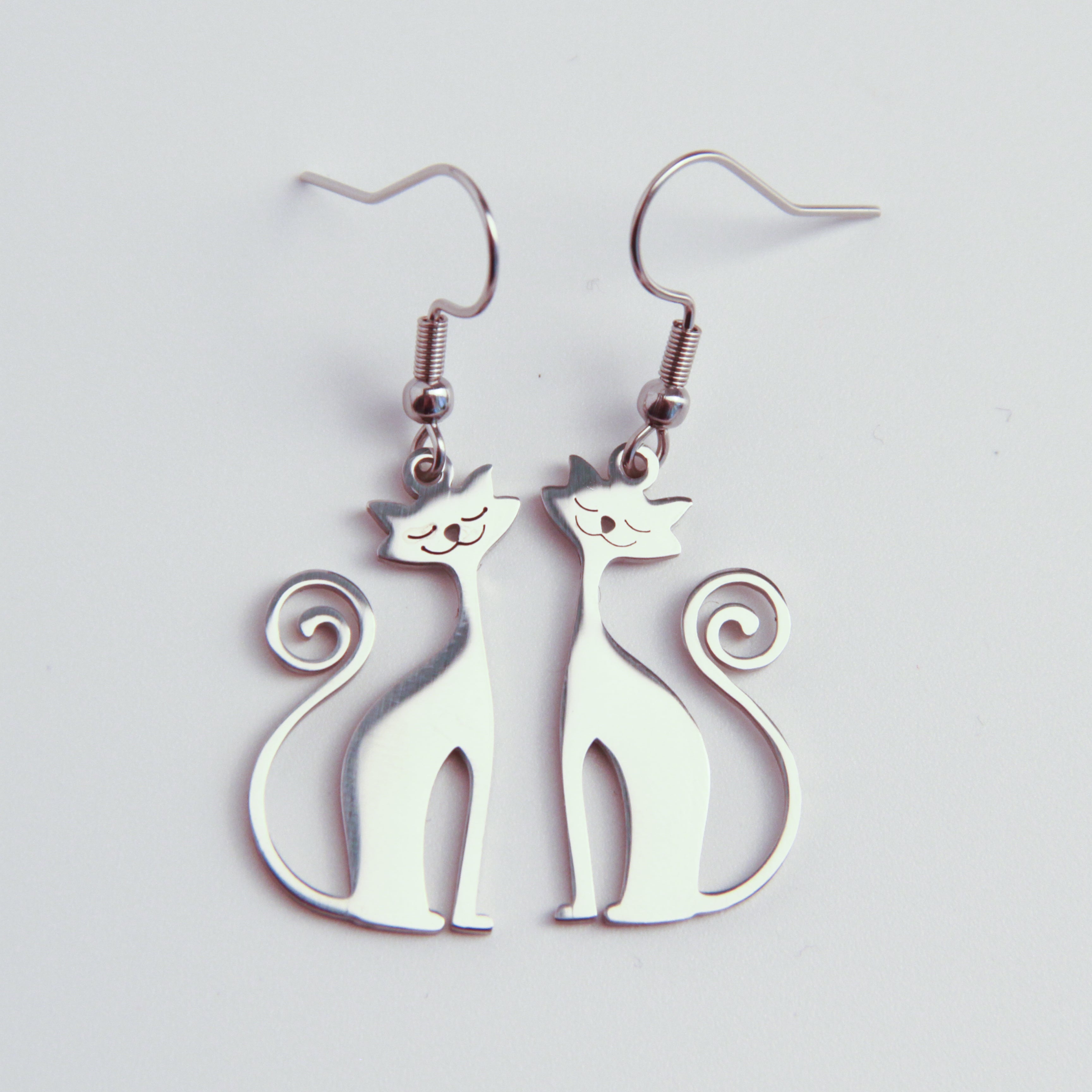 Silver cat earrings with minimalist silhouette design, lightweight dangling jewelry for cat lovers