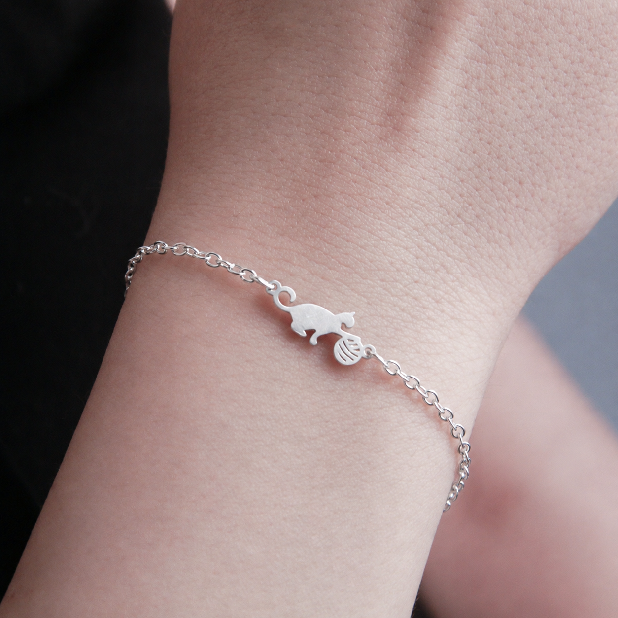Minimalist silver cat bracelet with elegant curved design, lightweight adjustable jewelry for cat lovers