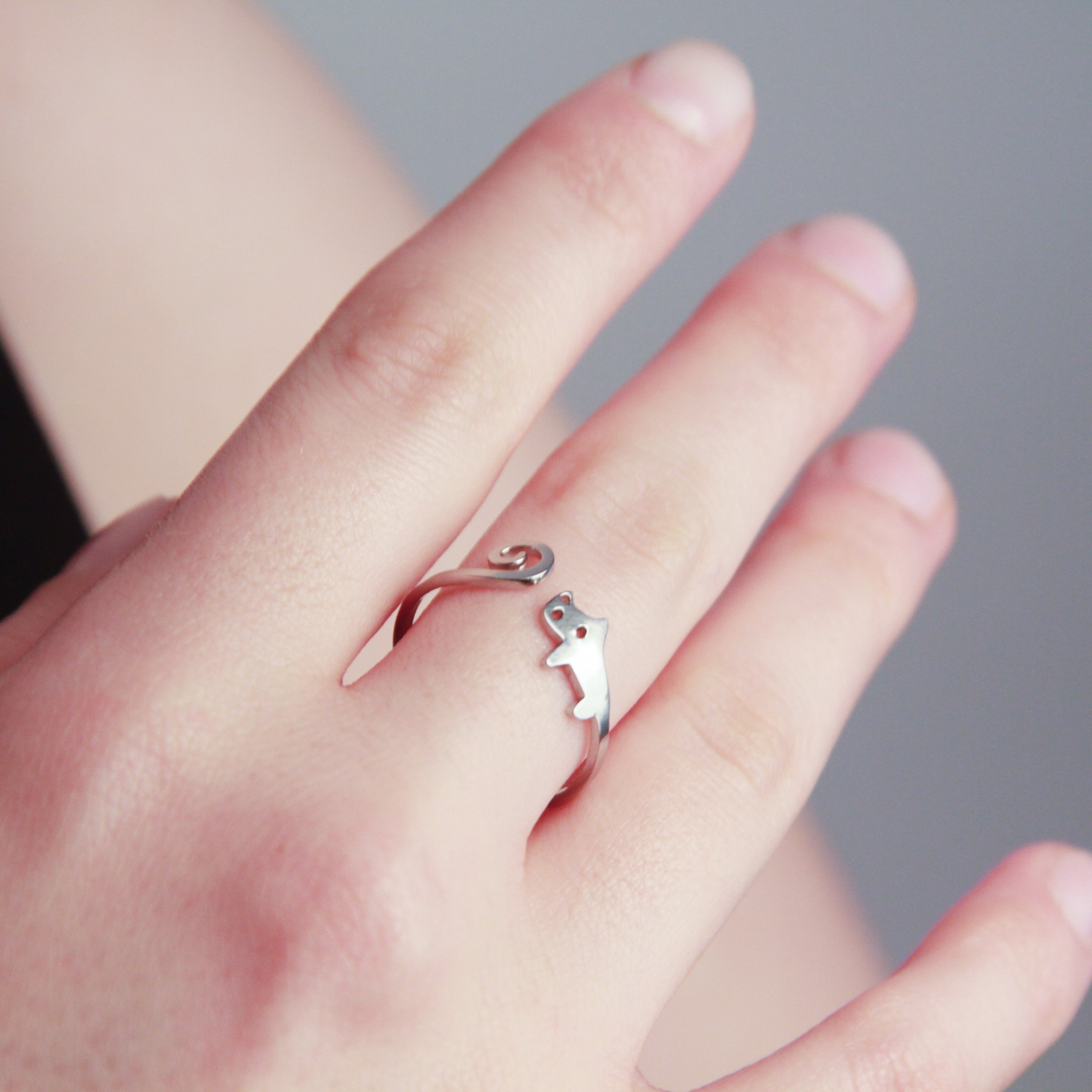 Adjustable silver cat ring with curled tail design, playful cat jewelry