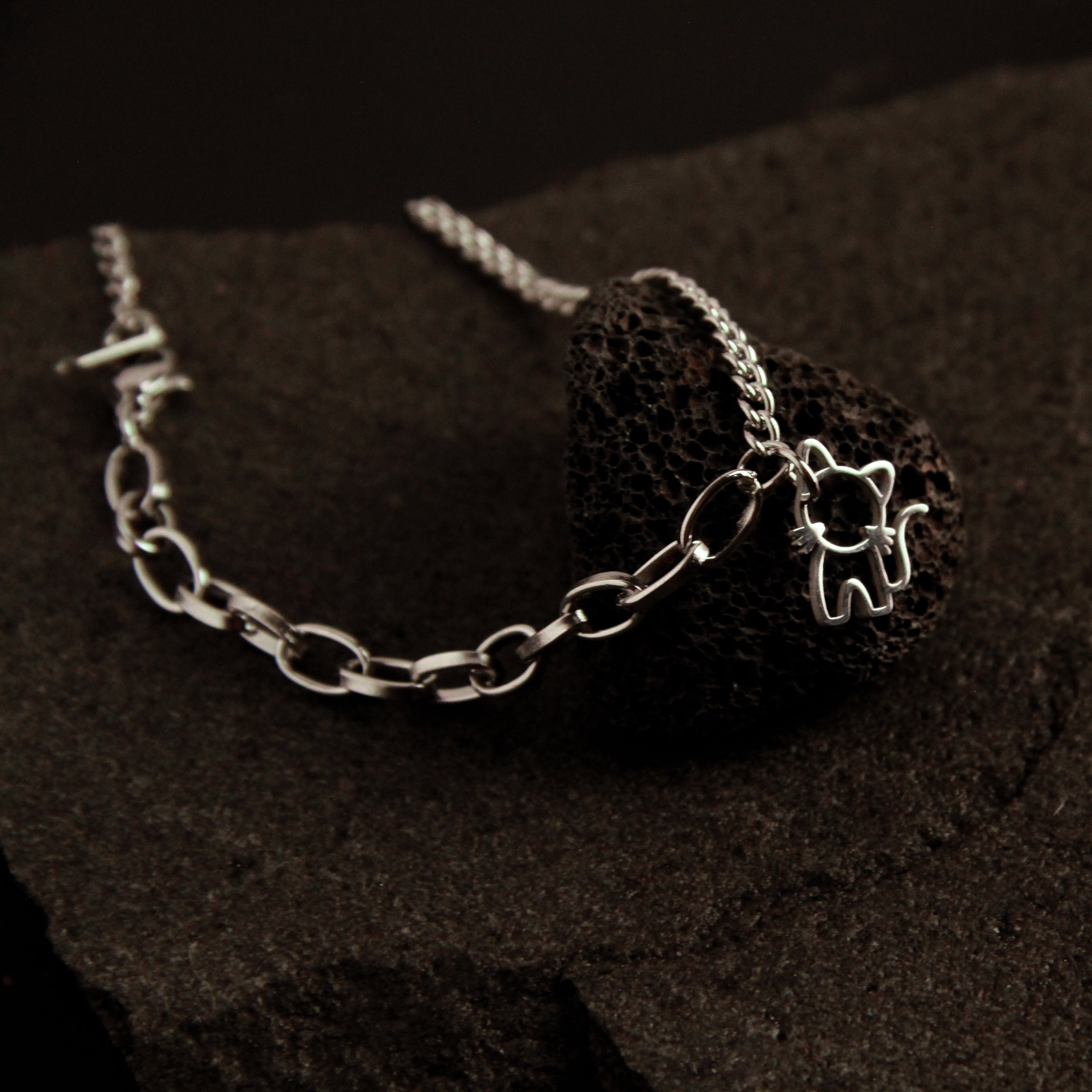 Modern layered silver cat bracelet featuring double chain links and a delicate cat charm, stylish jewelry for cat lovers