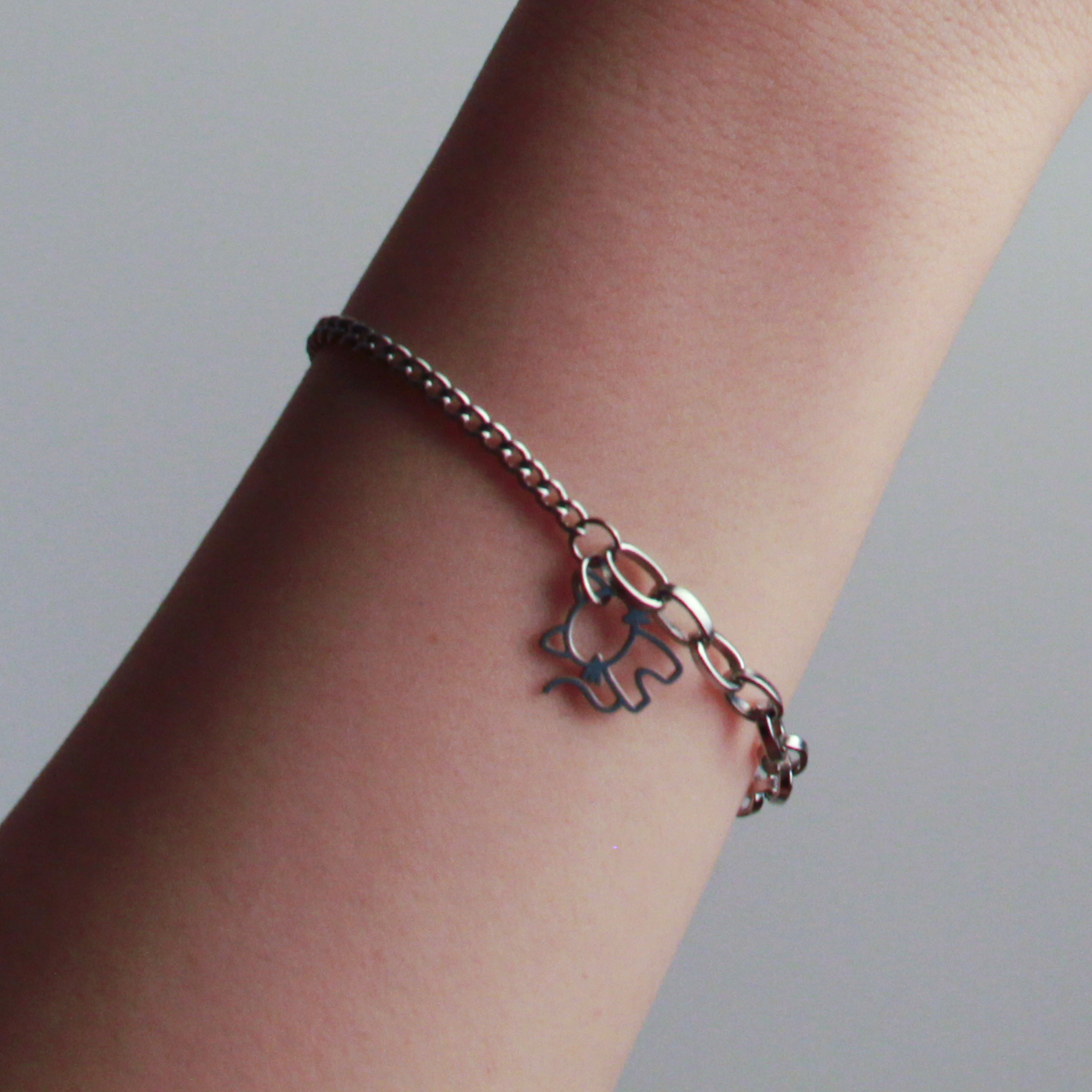 Elegant silver cat bracelet with layered chain design and minimalist feline charm, perfect for everyday wear