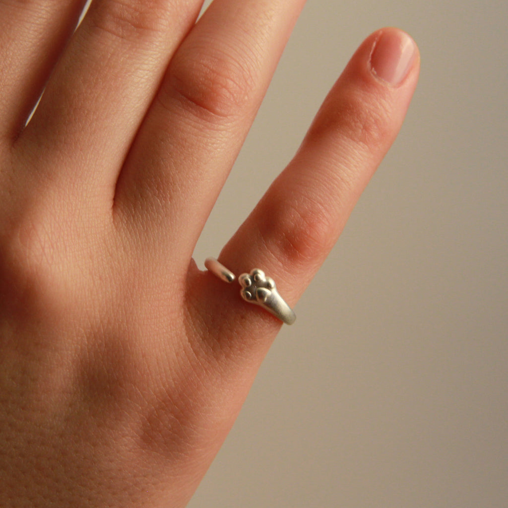 Cute silver paw ring with adjustable fit and delicate cat-inspired design, perfect gift for women