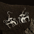 Twin Soul Cat Earrings displayed on dark stone background