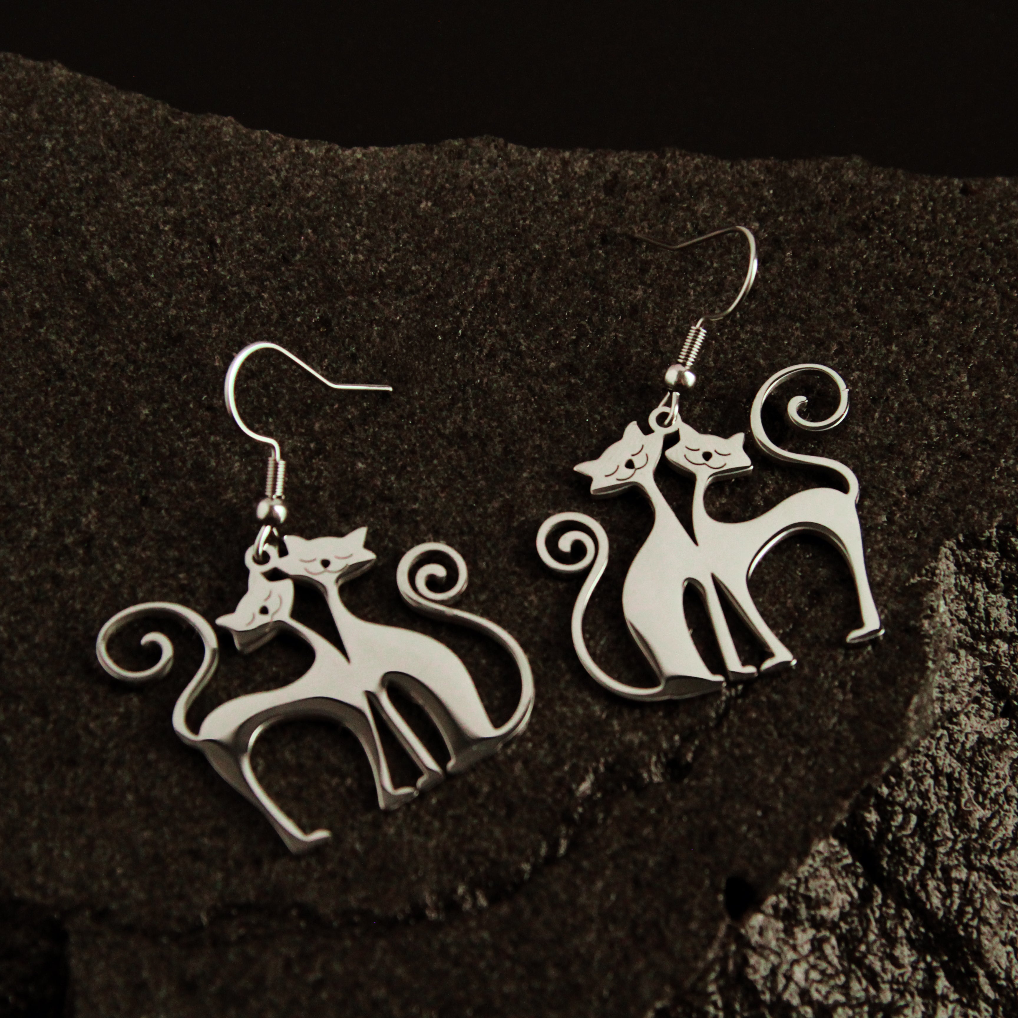 Twin Soul Cat Earrings displayed on dark stone background