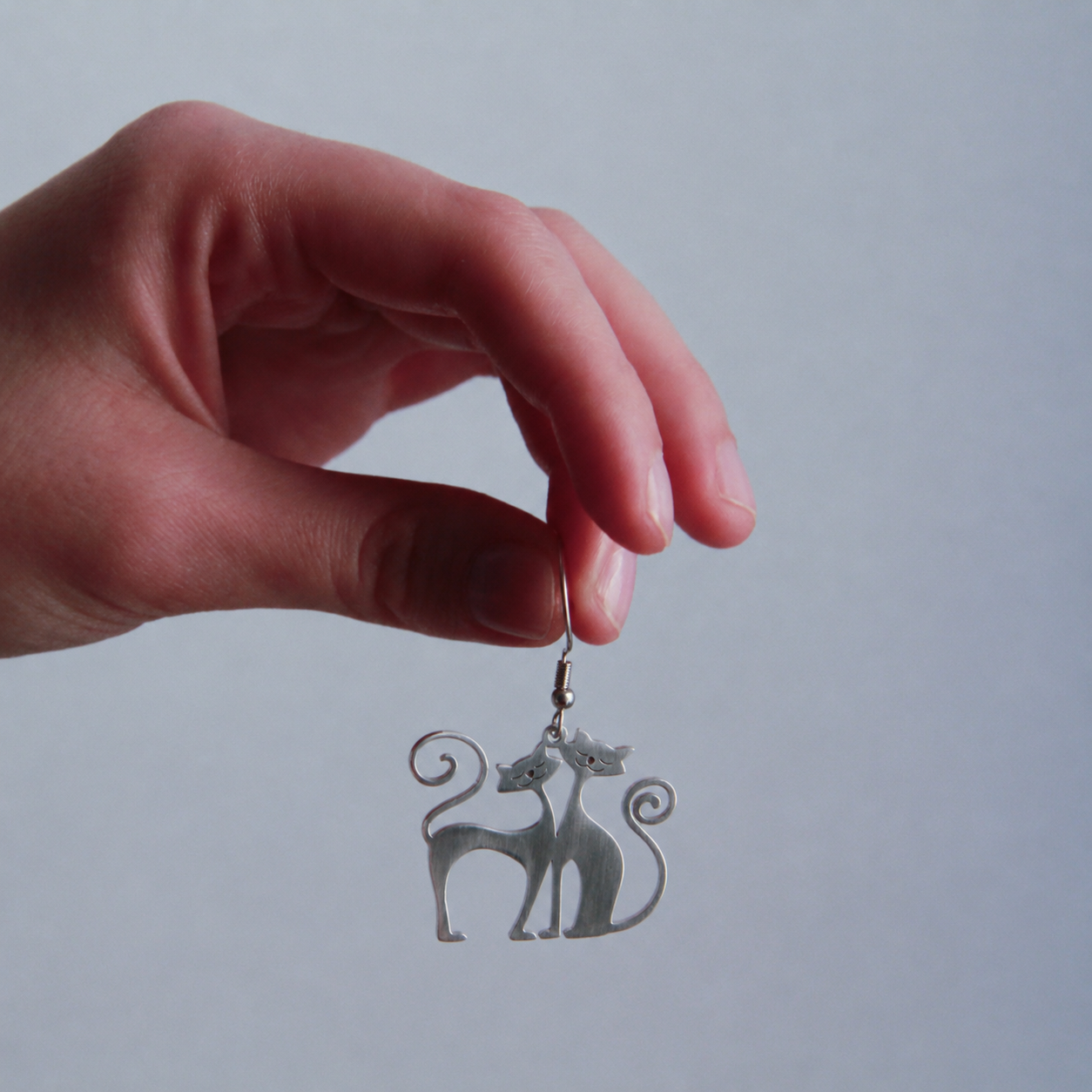 Woman wearing Twin Soul Cat Earrings silver cat jewelry