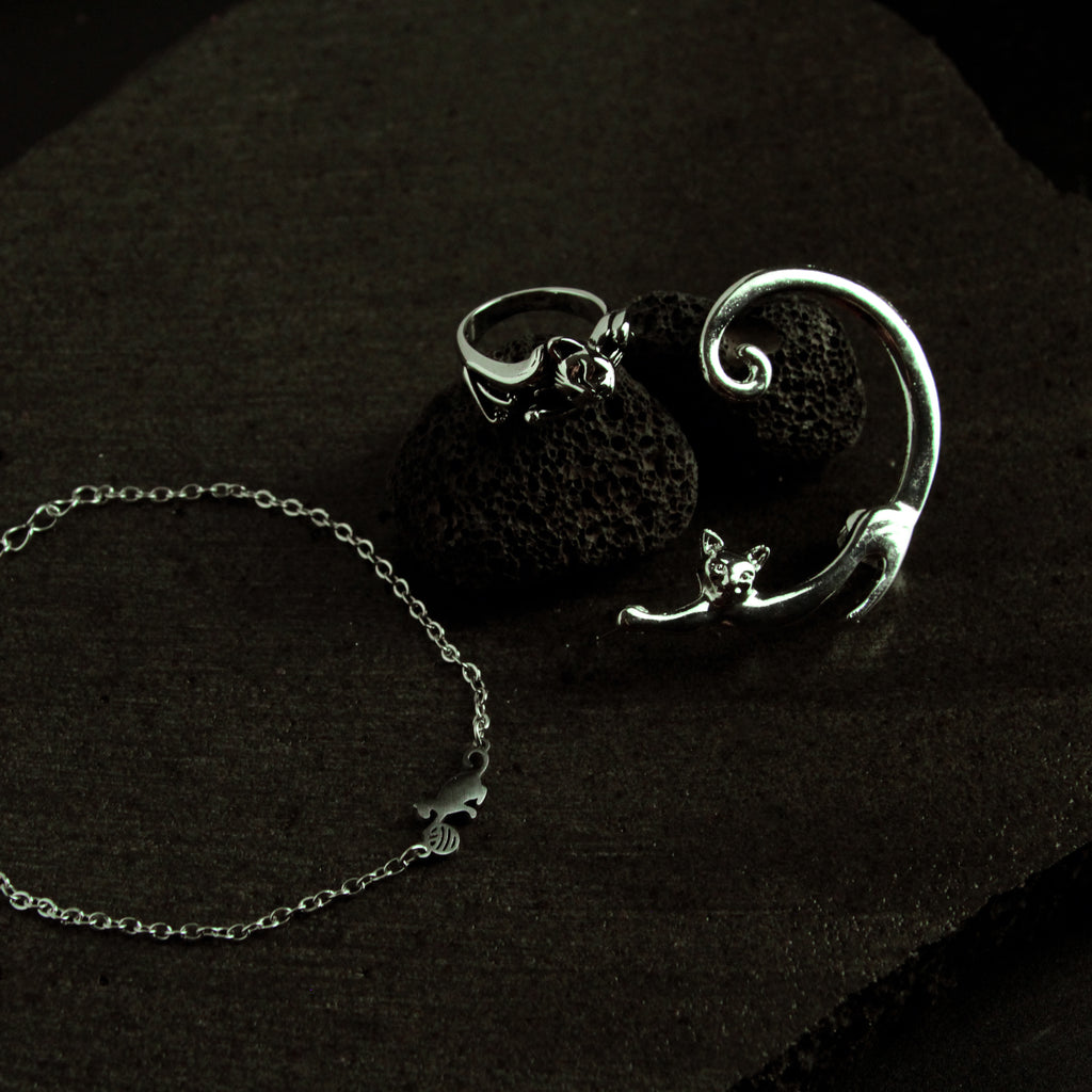Silver cat jewelry set featuring a curved bracelet and adjustable ring, stylish coordinated accessory set for women