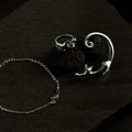 Silver cat jewelry set featuring a curved bracelet and adjustable ring, stylish coordinated accessory set for women