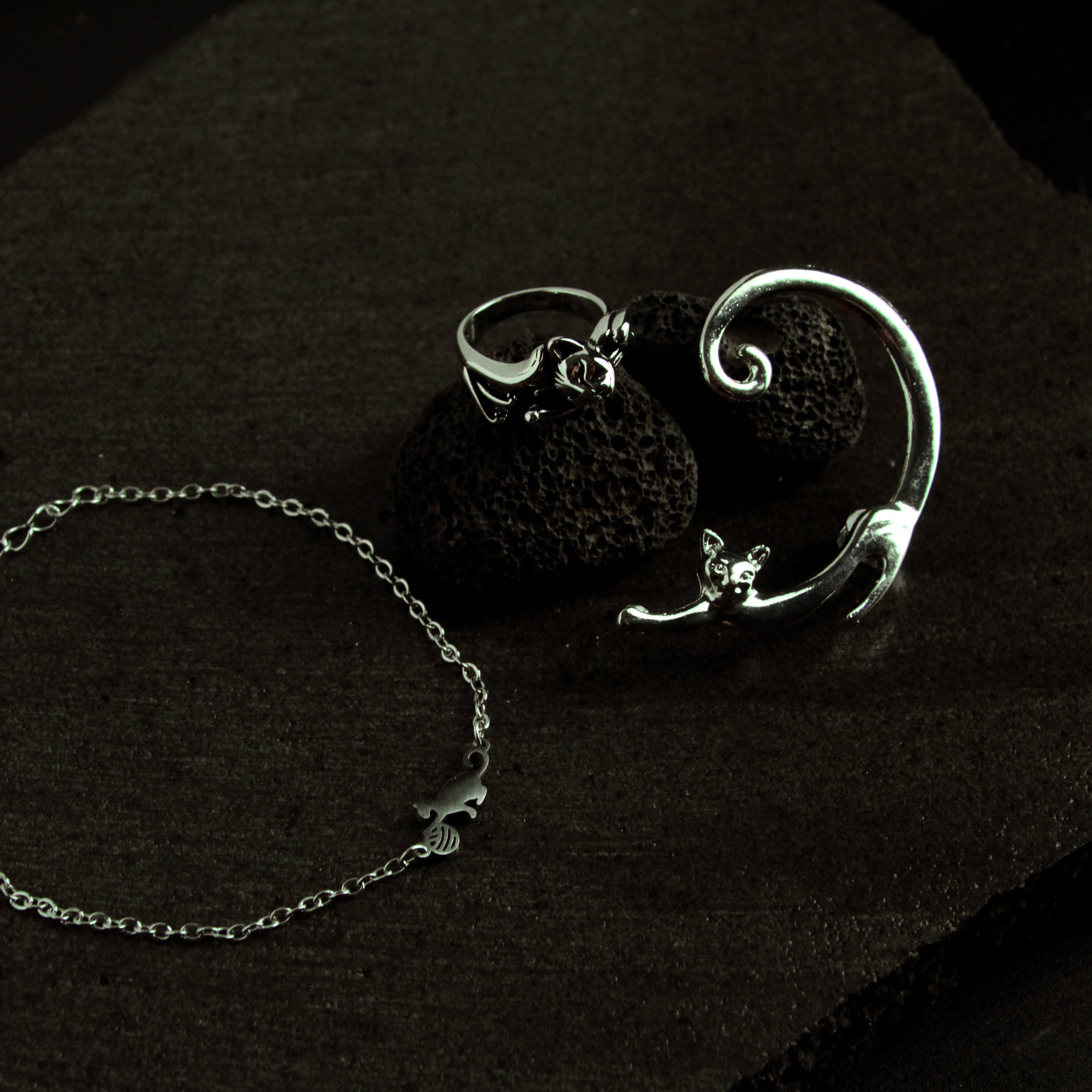Silver cat jewelry set featuring a curved bracelet and adjustable ring, stylish coordinated accessory set for women