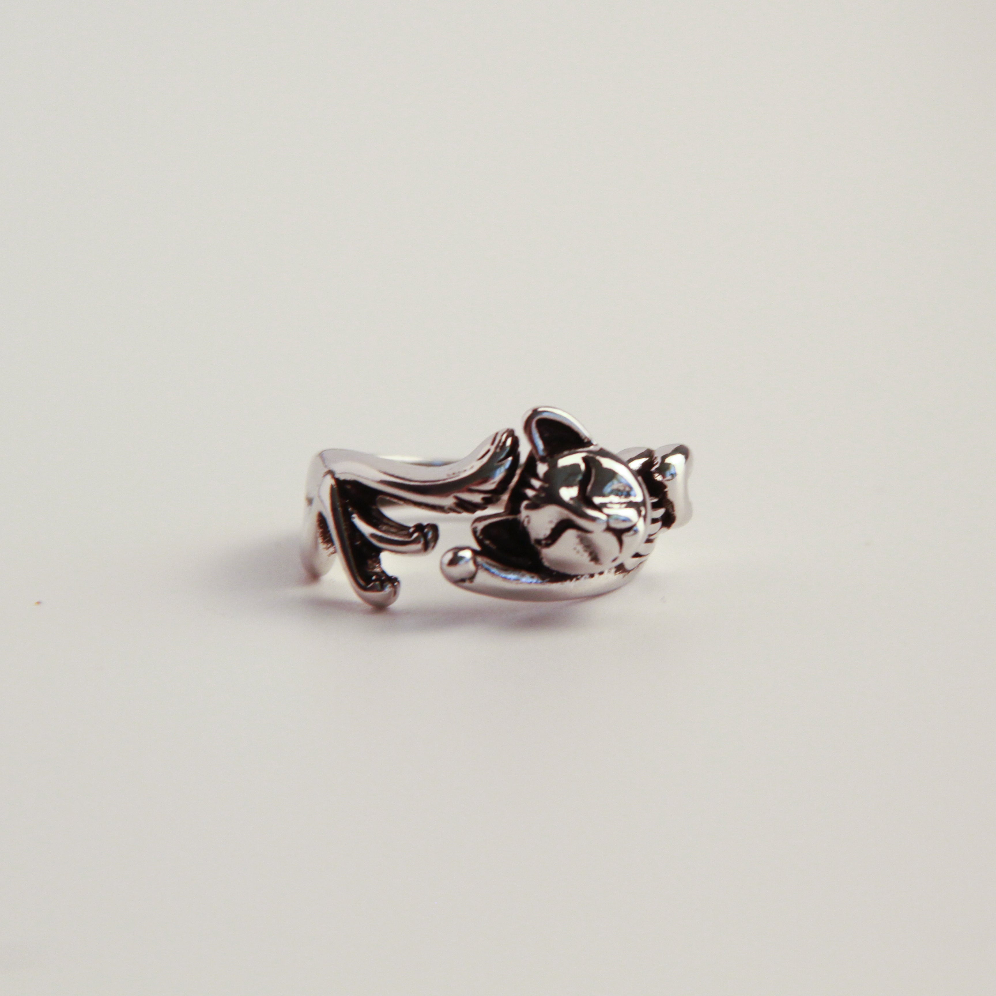 Elegant silver wrap cat ring with open design, adjustable accessory inspired by feline charm