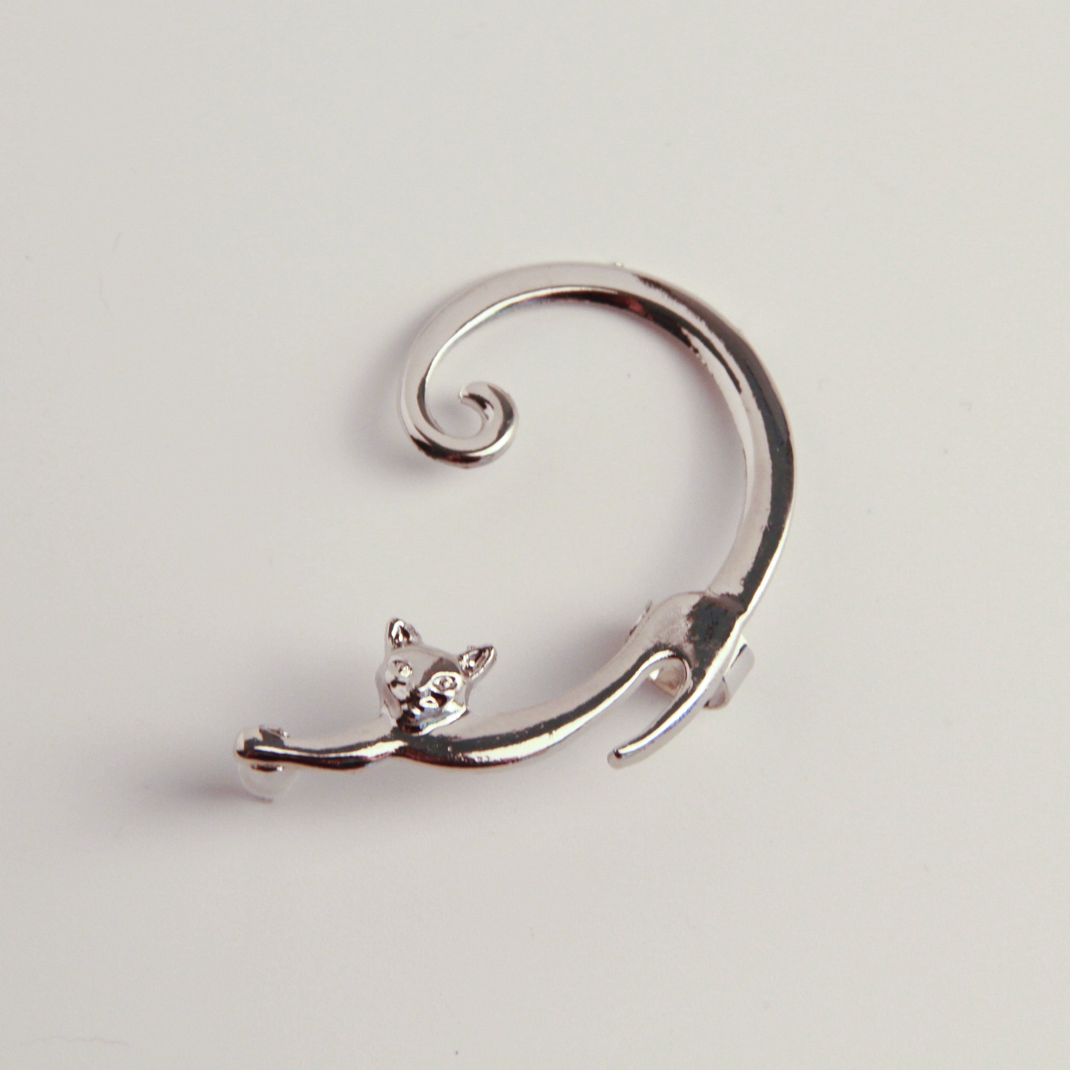 Minimalist silver cat earrings with playful charm accents, lightweight accessory for everyday wear