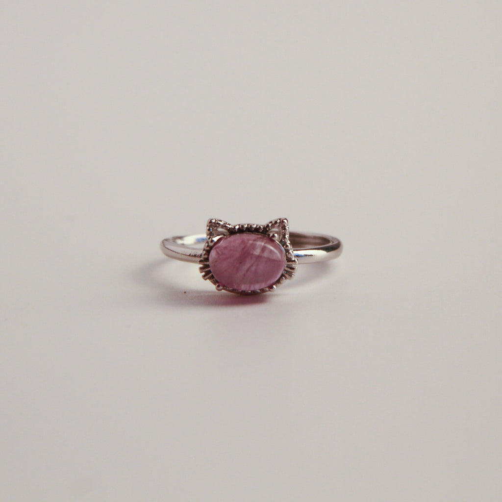 Metallic cat ring on a white background