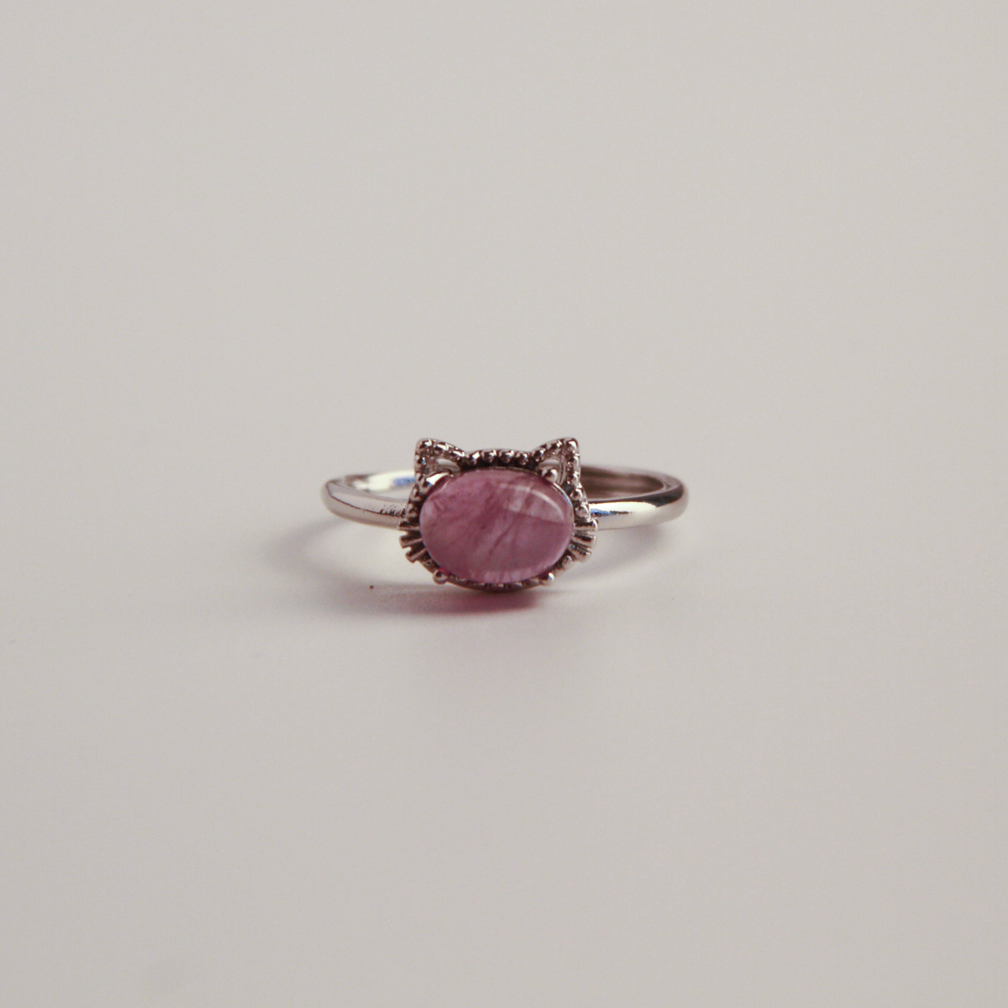 Metallic cat ring on a white background