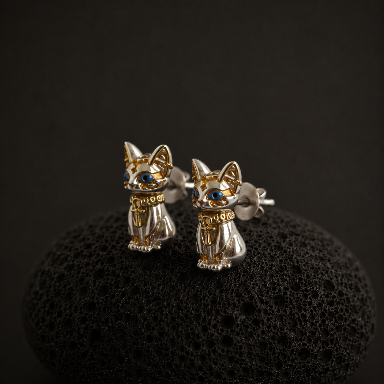 Pair of detailed cat stud earrings with blue enamel eyes