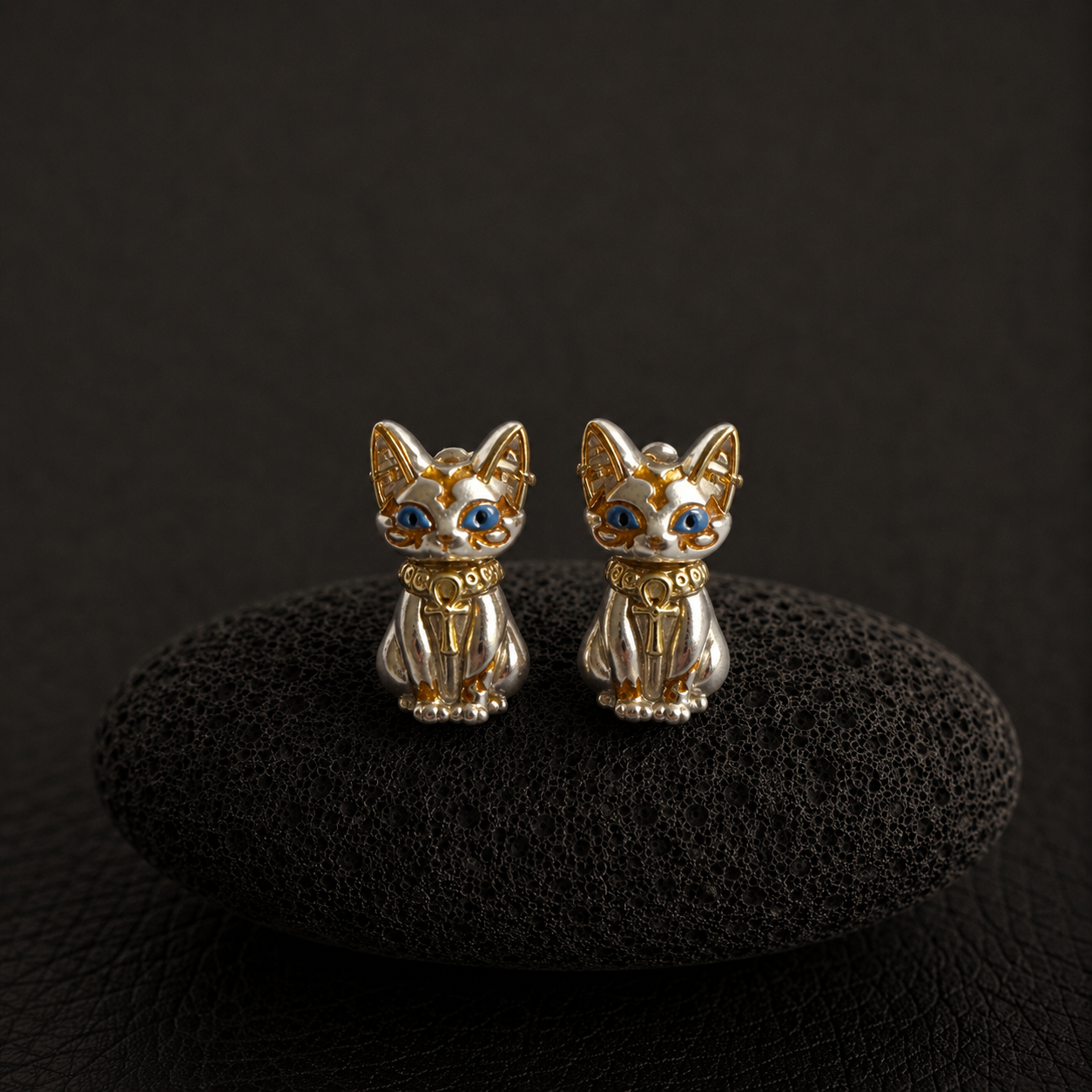 Bastet cat stud earrings with blue eyes and gold details