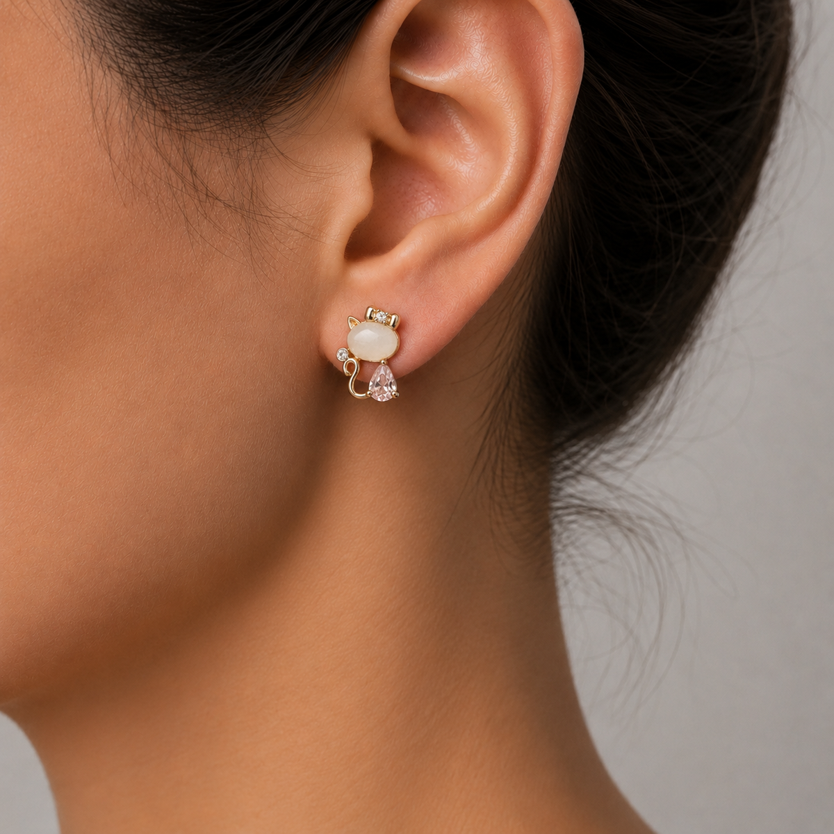 Blush Kitty cat earrings with pink teardrop stones and golden bows