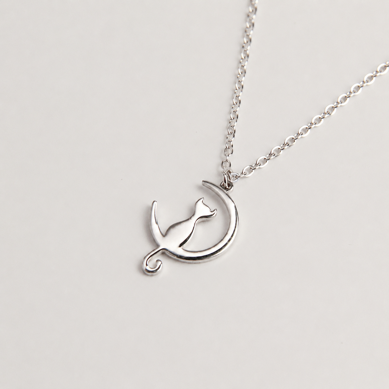 Silver cat necklace with curved cat silhouette pendant, minimalist jewelry for women
