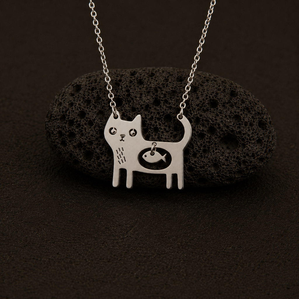 Cat Necklace displayed on black lava stone with silver chain.