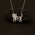 Cat Necklace displayed on black lava stone with silver chain.
