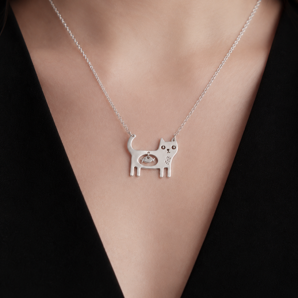 Woman wearing the Cat Necklace with minimalist black outfit.