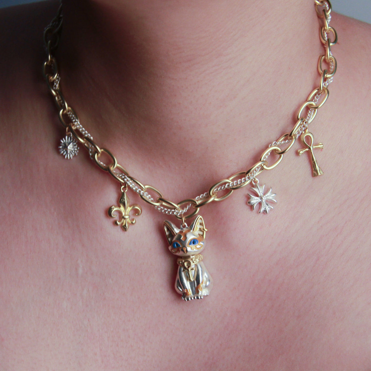 Close-up of white Pharaoh cat choker with ornate Egyptian-inspired pendant